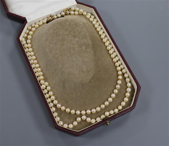 A Mikimoto pearl single strand long necklace with gold ball clasp (tests as 18ct) in Mikimoto box, 50 cm.